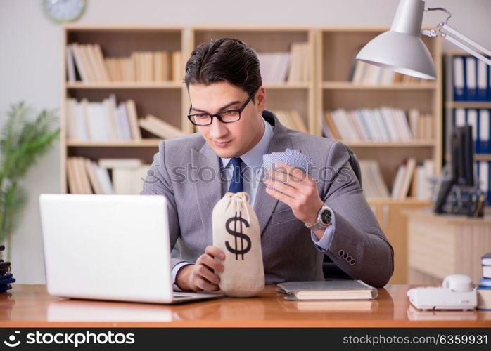 Businessman gambling playing cards at work