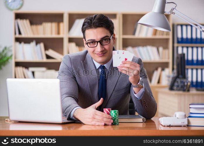 Businessman gambling playing cards at work