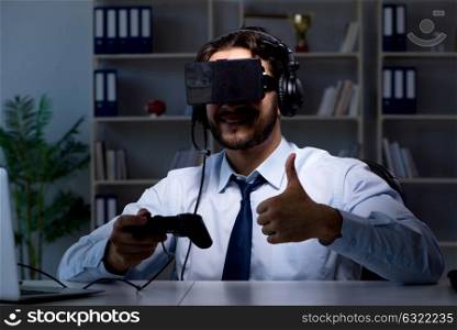 Businessman gamer staying late to play games