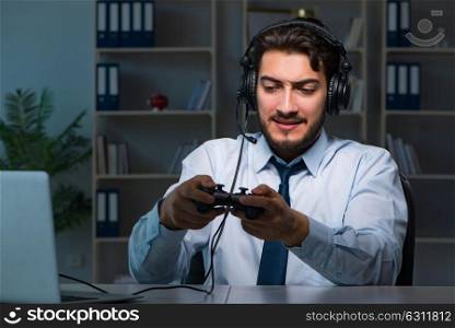 Businessman gamer staying late to play games. The businessman gamer staying late to play games