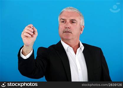 Businessman gesturing with pen