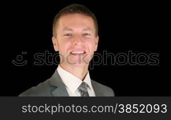 Businessman getting in focus, turns and smile, against black