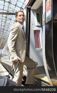 Businessman Getting On Train At Platform