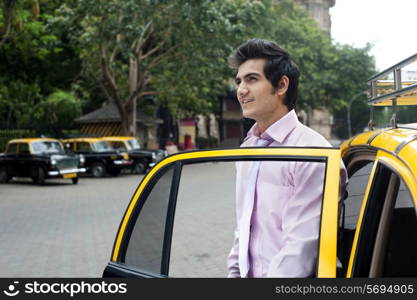 Businessman getting out of a taxi