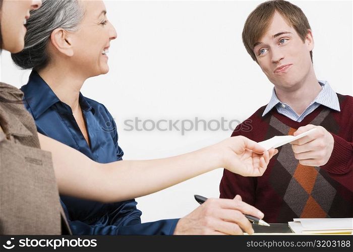 Businessman giving a paper to a businesswoman