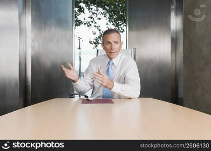 Businessman giving a presentation in a board room