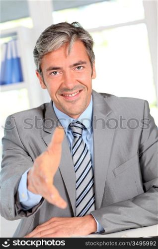 Businessman giving handshake to client
