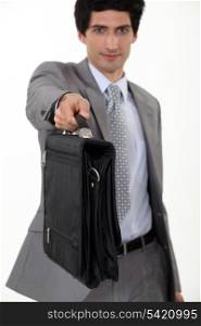 Businessman giving his briefcase