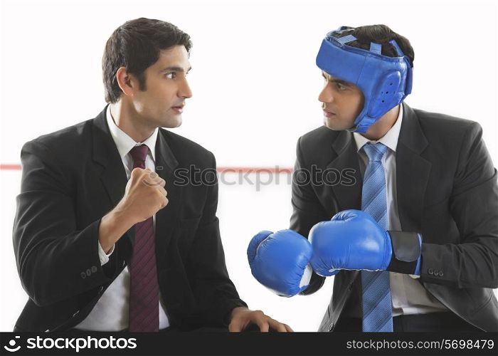 Businessman giving his friend boxing tips
