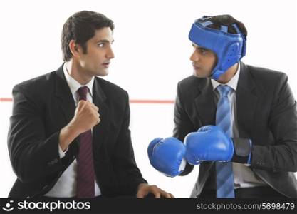 Businessman giving his friend boxing tips