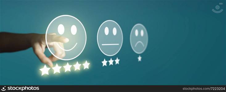 Businessman giving rating with smiley face emoticon on virtual touch screen, Customer satisfaction survey and Customer service evaluation concept.