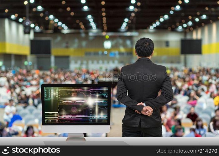 Businessman giving the knowledge with showing Cryptocurrency trading screen, Bitcoin exchange screen of trading information over blurred photo of attendee in Exhibition Center,Business Seminar concept