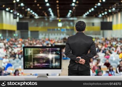 Businessman giving the knowledge with showing Cryptocurrency trading screen, Bitcoin exchange screen of trading information over blurred photo of attendee in Exhibition Center,Business Seminar concept