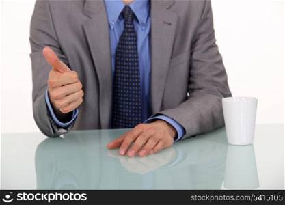 Businessman giving the thumb up.