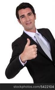 Businessman giving thumbs up gesture