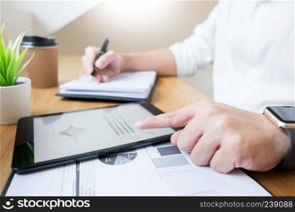 businessman going through some paperwork and signing a document at desk in office