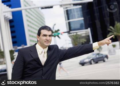 Businessman hailing a vehicle