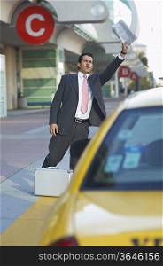 Businessman hailing taxi