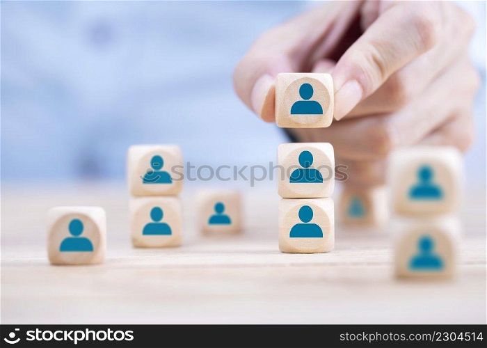 Businessman hand arranging wooden block with emoticon Person icons , Human resource management and recruitment business Organization structure and team building concept