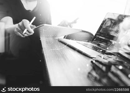 Businessman hand attending video conference with digital tablet computer and tablet computer at desk in office, black white