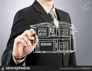 Businessman hand drawing house