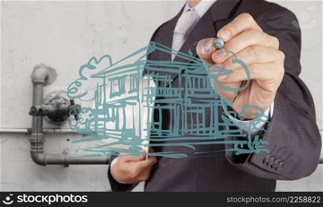 businessman hand drawing house model on modern computer as development concept
