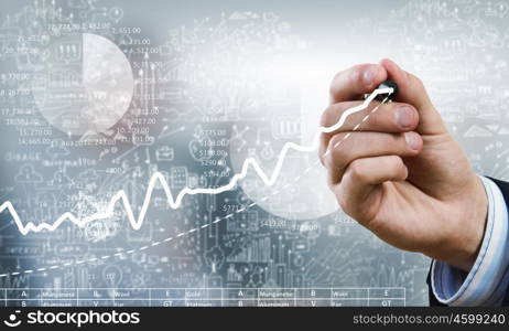 Businessman hand drawing increasing graph on media screen. Business and finance