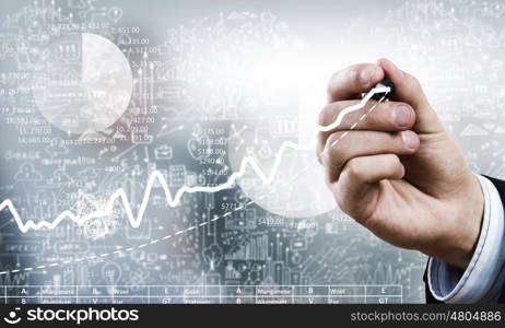 Businessman hand drawing increasing graph on media screen. Business and finance