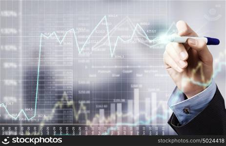 Businessman hand drawing increasing graph on media screen. Business and finance