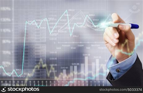 Businessman hand drawing increasing graph on media screen. Business and finance