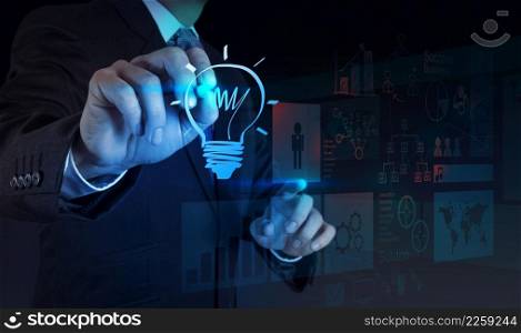 businessman hand draws lightbulb with new computer interface as solution business concept