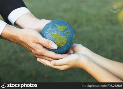 Businessman hand giving Earth globe to little boy as Earth day concept as corporate social responsible to contribute greener environmental protection for sustainable future generation. Gyre. Businessman hand giving Earth globe to little boy as Earth day concept. Gyre