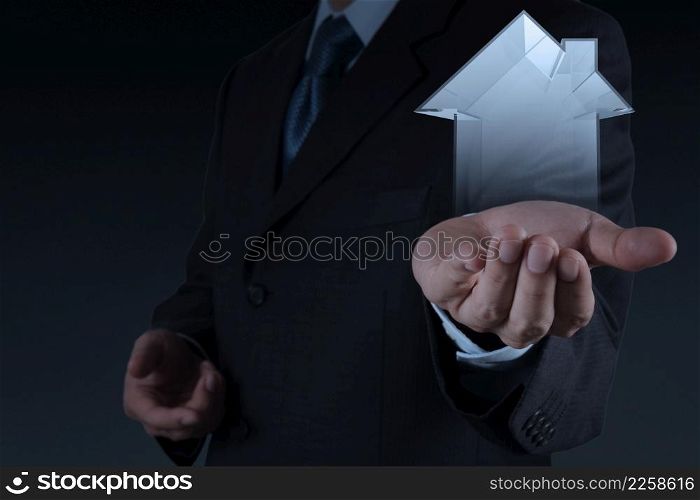 businessman hand holding 3d house as insurance concept