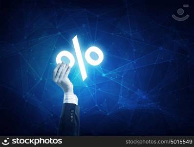 Businessman hand holding blue crystal ball with percent sign.. Businessman hand on connection background holding glowing discount symbol