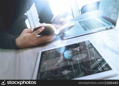 Businessman hand holding book and digital tablet.Photo finance manager working new Investment project office.Using new technology device.Graphic icons.Strategy business stock exchanges