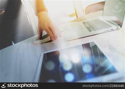 Businessman hand holding book and digital tablet.Photo finance manager working new Investment project office.Using new technology device.Graphic icons.Strategy business stock exchanges