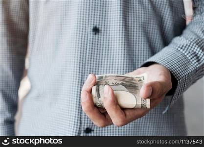 Businessman hand holding Japanese Yen banknote stack. business, money, investment , finance and payment concepts