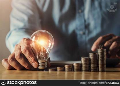 businessman hand holding light bulb. idea concept with innovation and inspiration. idea finance accounting