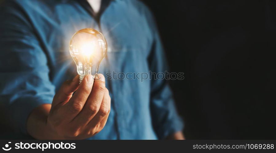 businessman hand holding lightbulb. idea Alternative energy concept saving electricity