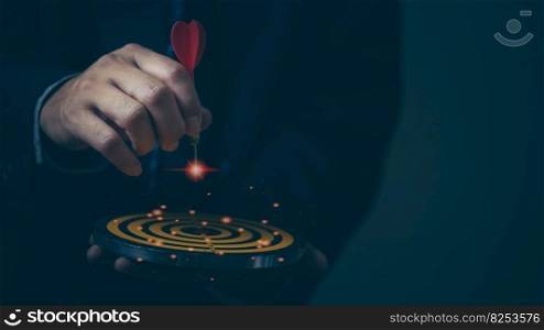 Businessman hand holding red dart to the virtual target dartboard marketing strategy goal and target for business investment concept.