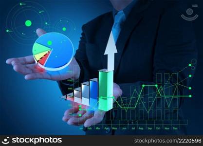 businessman hand holds graph bar and pie growth as concept