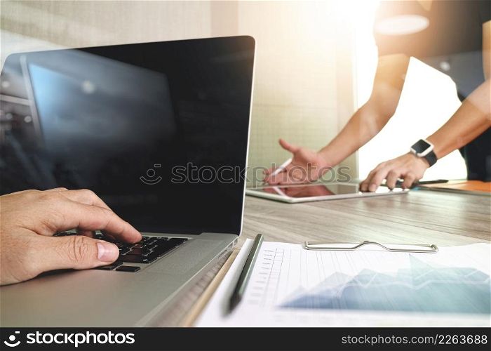 Businessman hand making presentation with his colleagues and business strategy digital layer effect at the office as concept