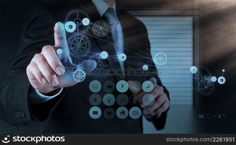 businessman hand pointing to the gear to success as concept