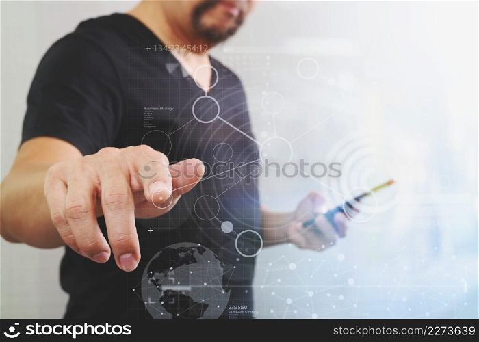 Businessman hand pressing an imaginary button,holding smart phone,digital screen graphic virtual icons,graph,diagram