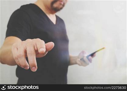 Businessman hand pressing an imaginary button,holding smart phone,digital screen graphic virtual icons,graph,diagram,filter effect