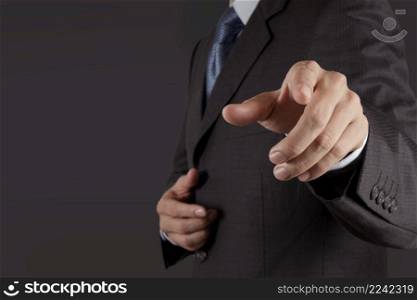 Businessman hand pressing an imaginary button on virtual screen