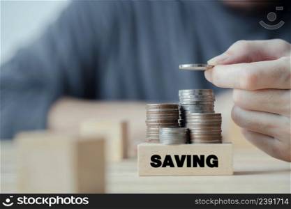 Businessman hand putting coin stack for saving money, budget, investment or strategy for personal saving, concept saving money for finance accounting
