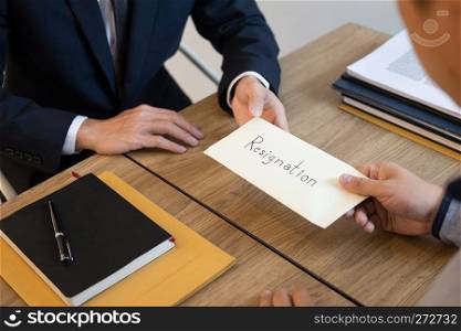 businessman hand sending a resignation letter to executive boss dismissed worker quit out from company, Change job, unemployment, resign concept.