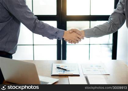 businessman hand shaking at a office