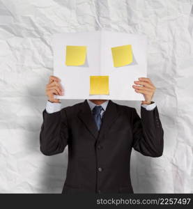 businessman hand show blank cover book and sticky note with crumpled recycle paper background 